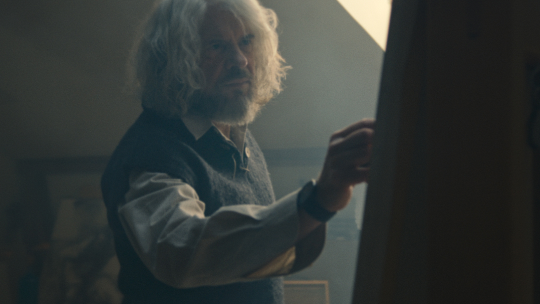 Elderly painter at an easel