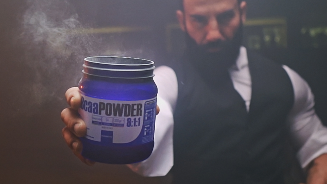 Man holding a powder tub toward the camera